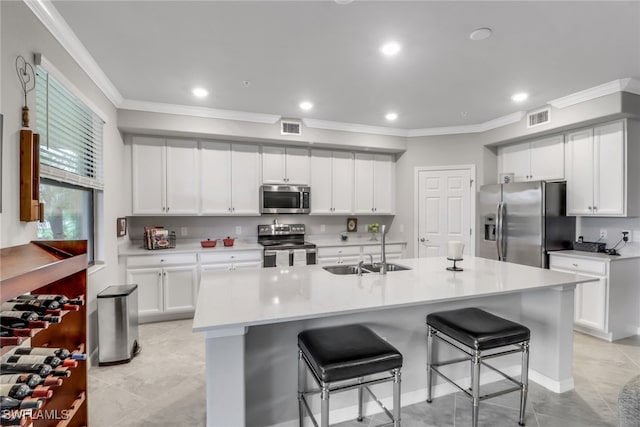 kitchen with white cabinets, a large island, stainless steel appliances, and sink