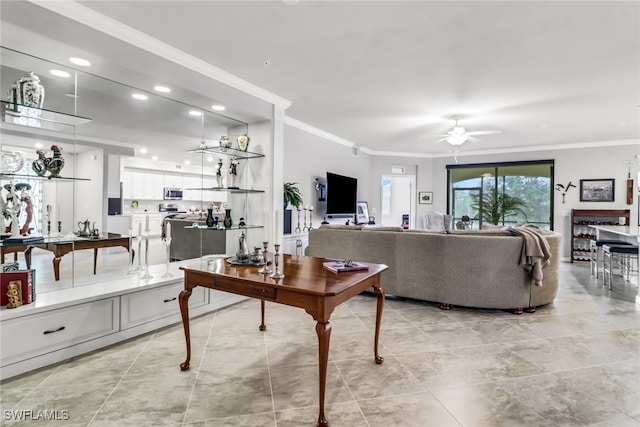 living room featuring ornamental molding and ceiling fan