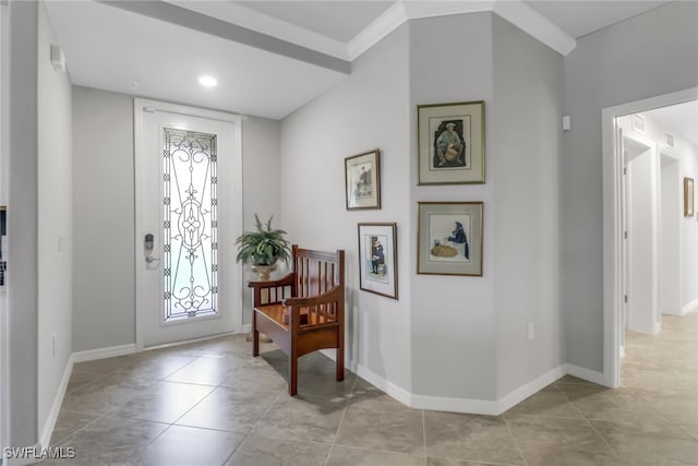 entryway featuring light tile patterned flooring and ornamental molding