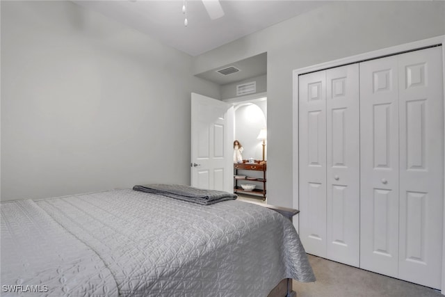 bedroom featuring ceiling fan, a closet, and light colored carpet