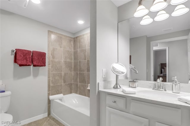 full bathroom with tiled shower / bath combo, vanity, tile patterned flooring, and toilet