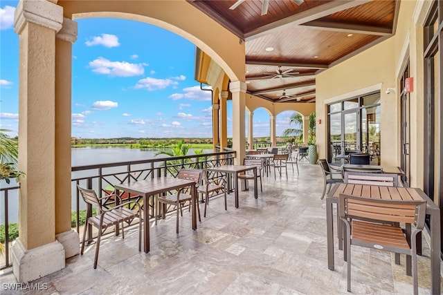 view of patio / terrace with a water view and ceiling fan