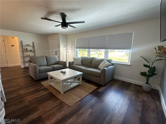 living room featuring a textured ceiling, ceiling fan, and dark hardwood / wood-style flooring