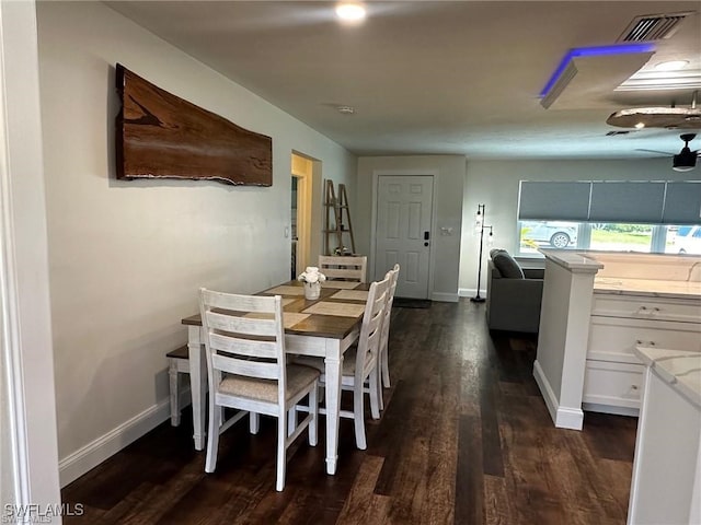 dining area with dark hardwood / wood-style floors