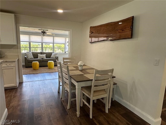 dining space featuring dark wood-type flooring and ceiling fan