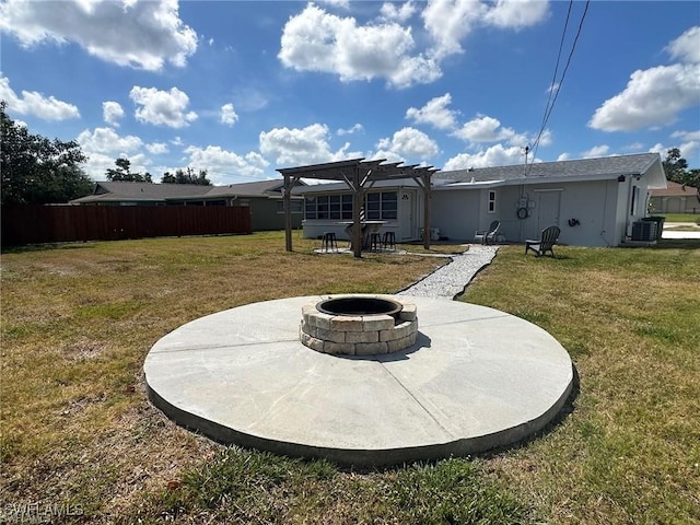 rear view of house featuring an outdoor fire pit, a patio, a yard, and central air condition unit