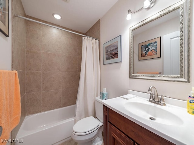 full bathroom with vanity, shower / tub combo with curtain, and toilet