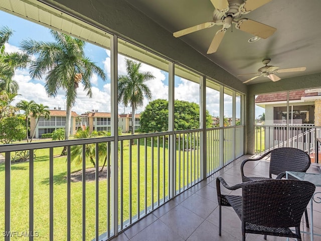 sunroom featuring ceiling fan