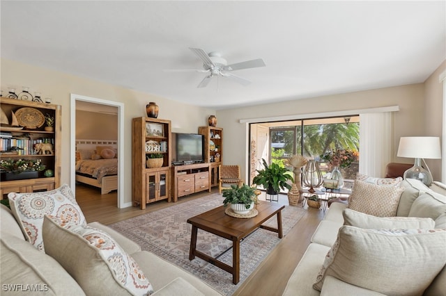 living room with light hardwood / wood-style floors and ceiling fan