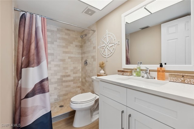 bathroom with vanity, hardwood / wood-style floors, toilet, and walk in shower