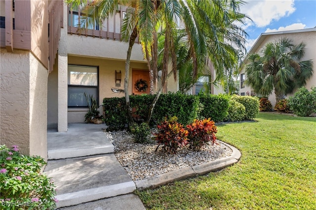 property entrance with a lawn