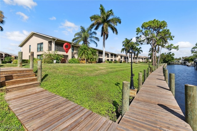 dock area featuring a water view and a yard