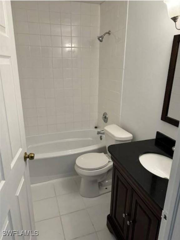 full bathroom with toilet, vanity, tile patterned floors, and tiled shower / bath combo