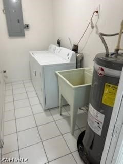 washroom featuring light tile patterned floors, washer / clothes dryer, electric water heater, and electric panel