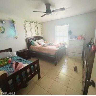 bedroom featuring light tile patterned floors and ceiling fan