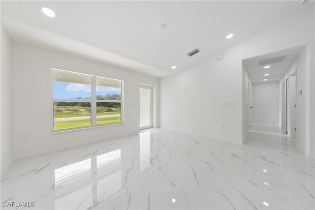 spare room with vaulted ceiling