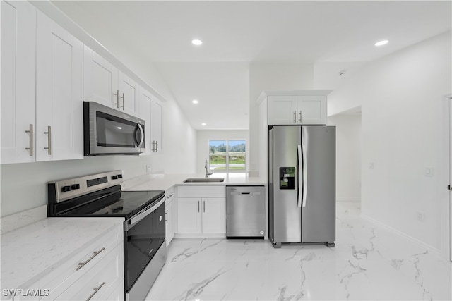 kitchen featuring sink, stainless steel appliances, lofted ceiling, white cabinets, and light stone counters