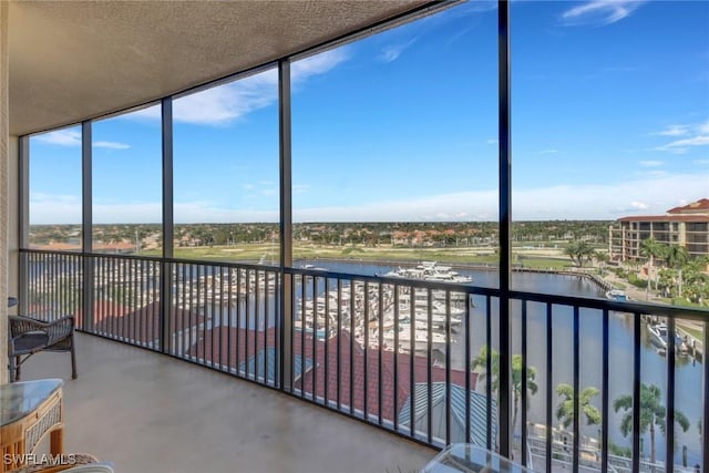 unfurnished sunroom with a water view