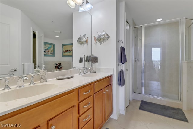 bathroom with vanity, a shower with shower door, and tile patterned floors