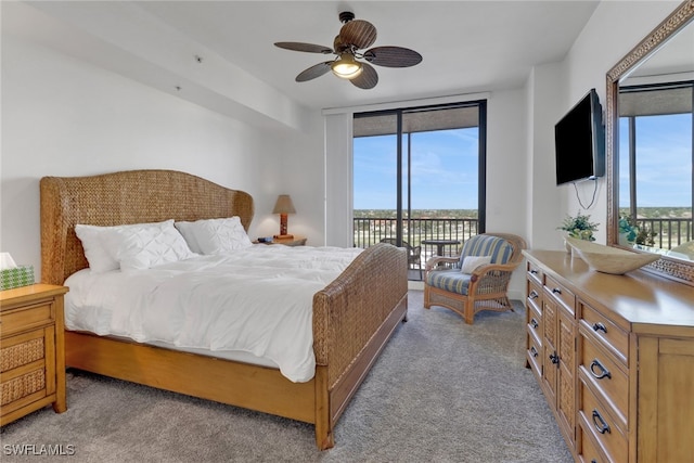 carpeted bedroom with ceiling fan, access to exterior, and floor to ceiling windows