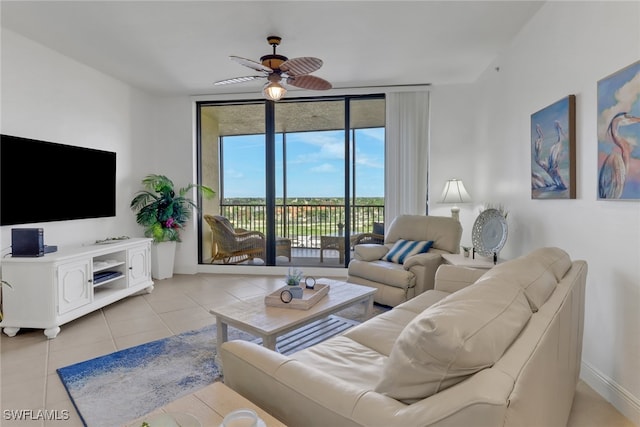 tiled living room with expansive windows and ceiling fan