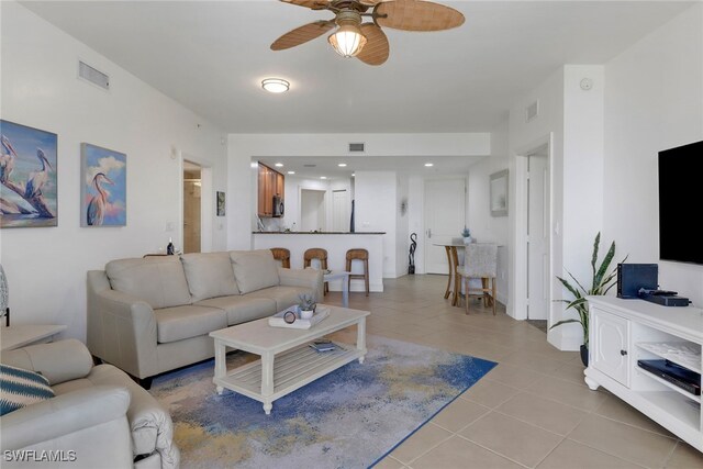 living room with ceiling fan and light tile patterned floors