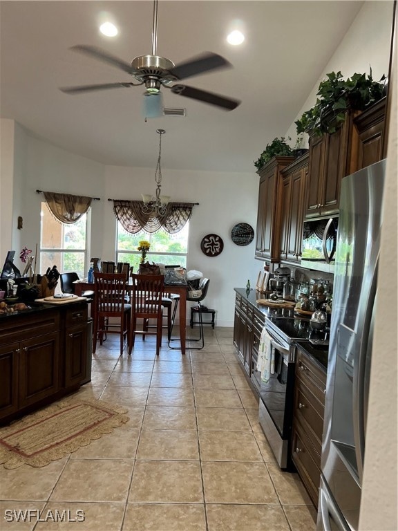 kitchen with dark brown cabinets, light tile patterned flooring, appliances with stainless steel finishes, and ceiling fan