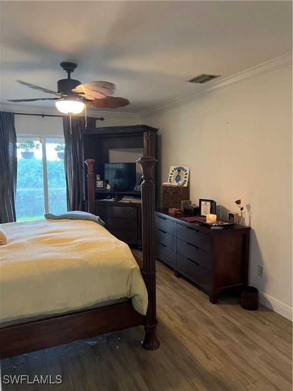 bedroom featuring ceiling fan, crown molding, and dark wood-type flooring