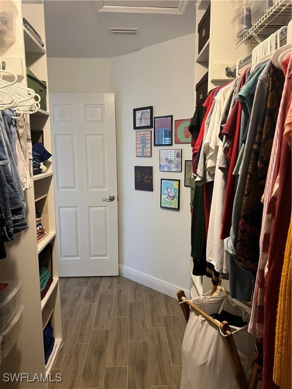 walk in closet featuring hardwood / wood-style flooring