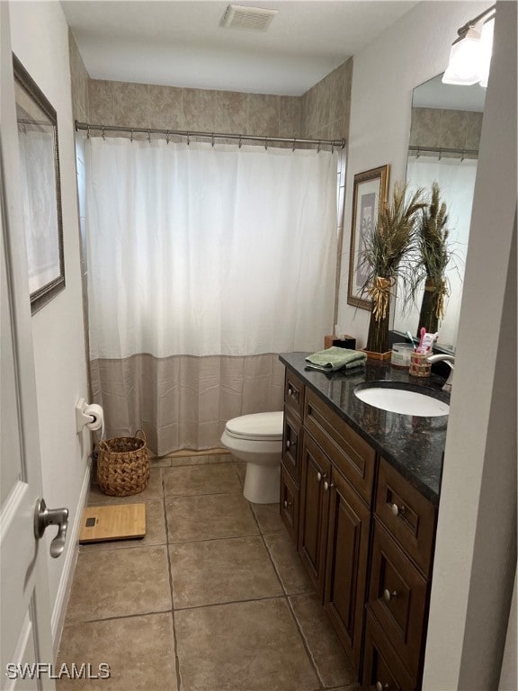 bathroom with vanity, tile patterned flooring, toilet, and a shower with shower curtain