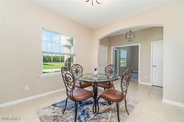 dining space with an inviting chandelier and light tile patterned floors