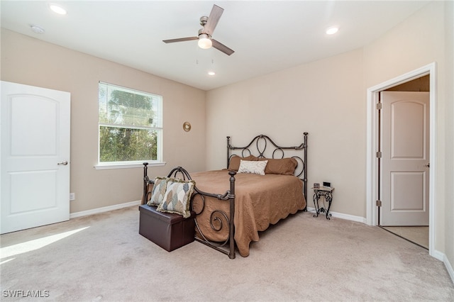 bedroom with ceiling fan and light colored carpet