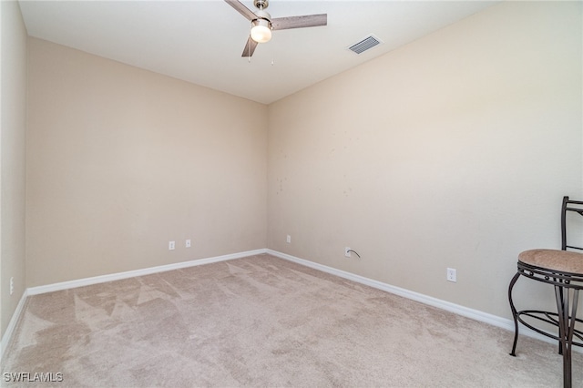 carpeted empty room featuring ceiling fan