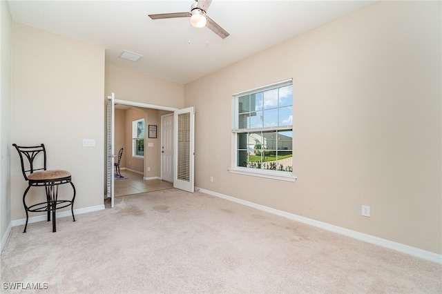 carpeted empty room featuring ceiling fan