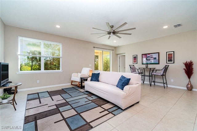 living room featuring ceiling fan and a healthy amount of sunlight