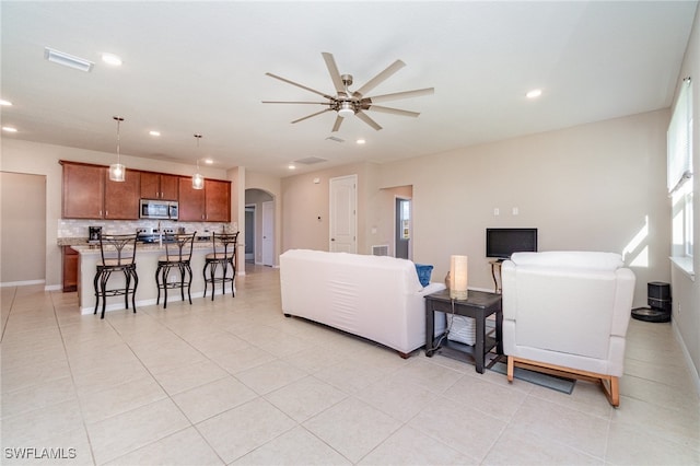 living room featuring ceiling fan and light tile patterned flooring