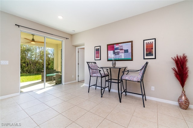 tiled dining room with ceiling fan