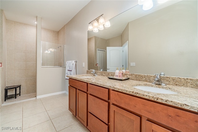 bathroom featuring vanity, tile patterned floors, and tiled shower