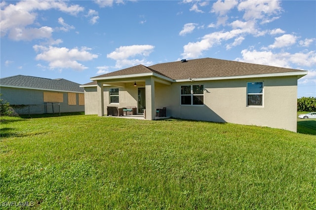 rear view of house with a lawn, a patio area, and ceiling fan