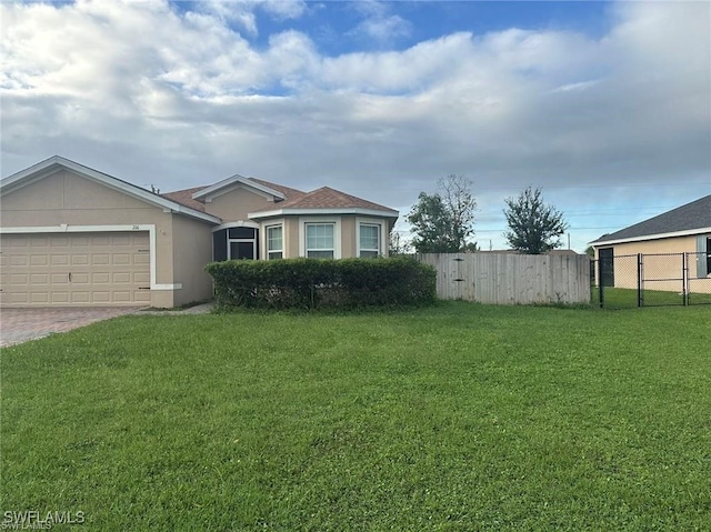 view of front of house with a garage and a front lawn