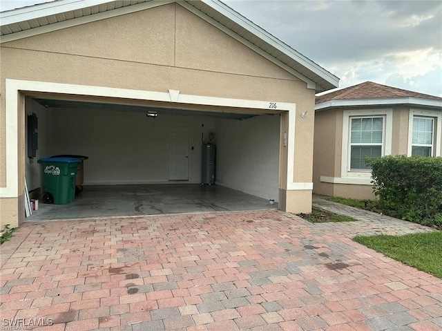 garage with electric panel and water heater