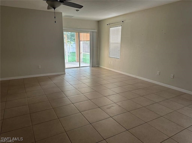 tiled empty room with ceiling fan