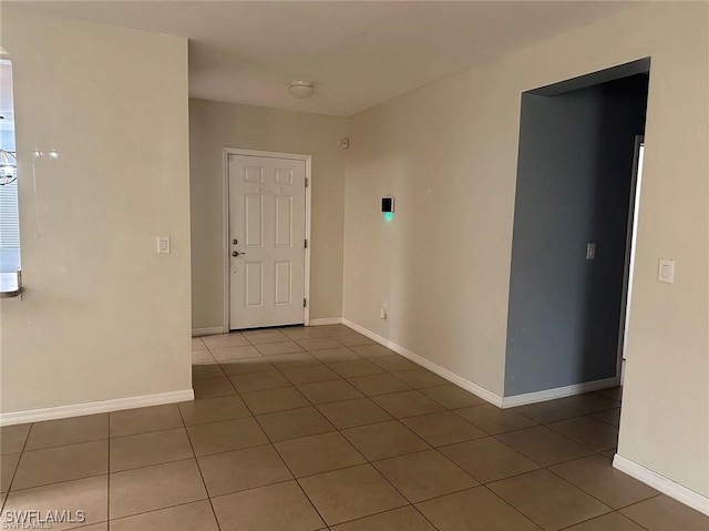 empty room featuring dark tile patterned floors