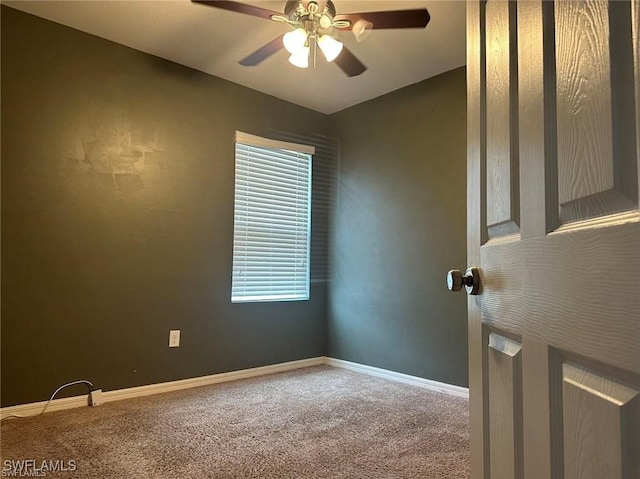 carpeted spare room with ceiling fan