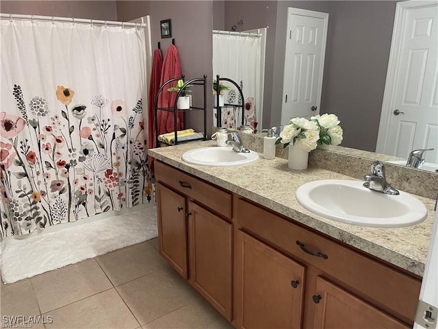 bathroom with tile patterned floors, walk in shower, and vanity