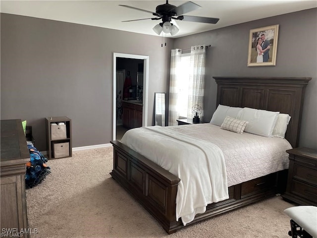 carpeted bedroom with ceiling fan and connected bathroom