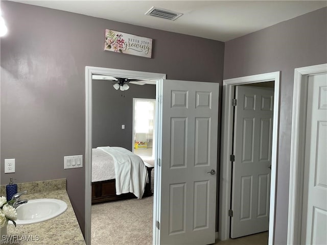 bathroom featuring ceiling fan and vanity