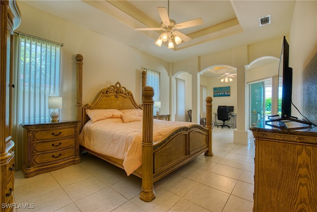 bedroom with access to outside, decorative columns, light tile patterned floors, and ceiling fan