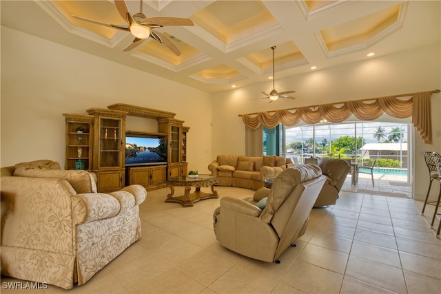 living room featuring coffered ceiling, light tile patterned floors, and ceiling fan