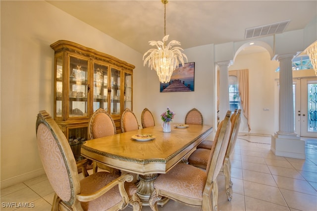 tiled dining space with a notable chandelier and a wealth of natural light